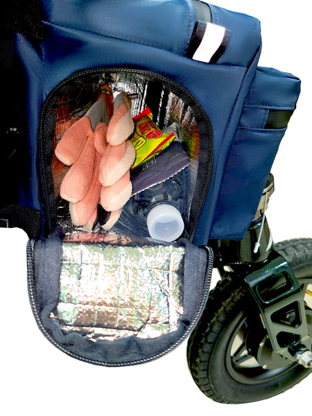 Buddy Sport Cooler close-up side view. Opened side compartment is arch-shaped with a silver thermal insulated lining, single compartment. Inside contents are pink gloves, granola bar , snack pack and Water bottle. Reflective tabs.
