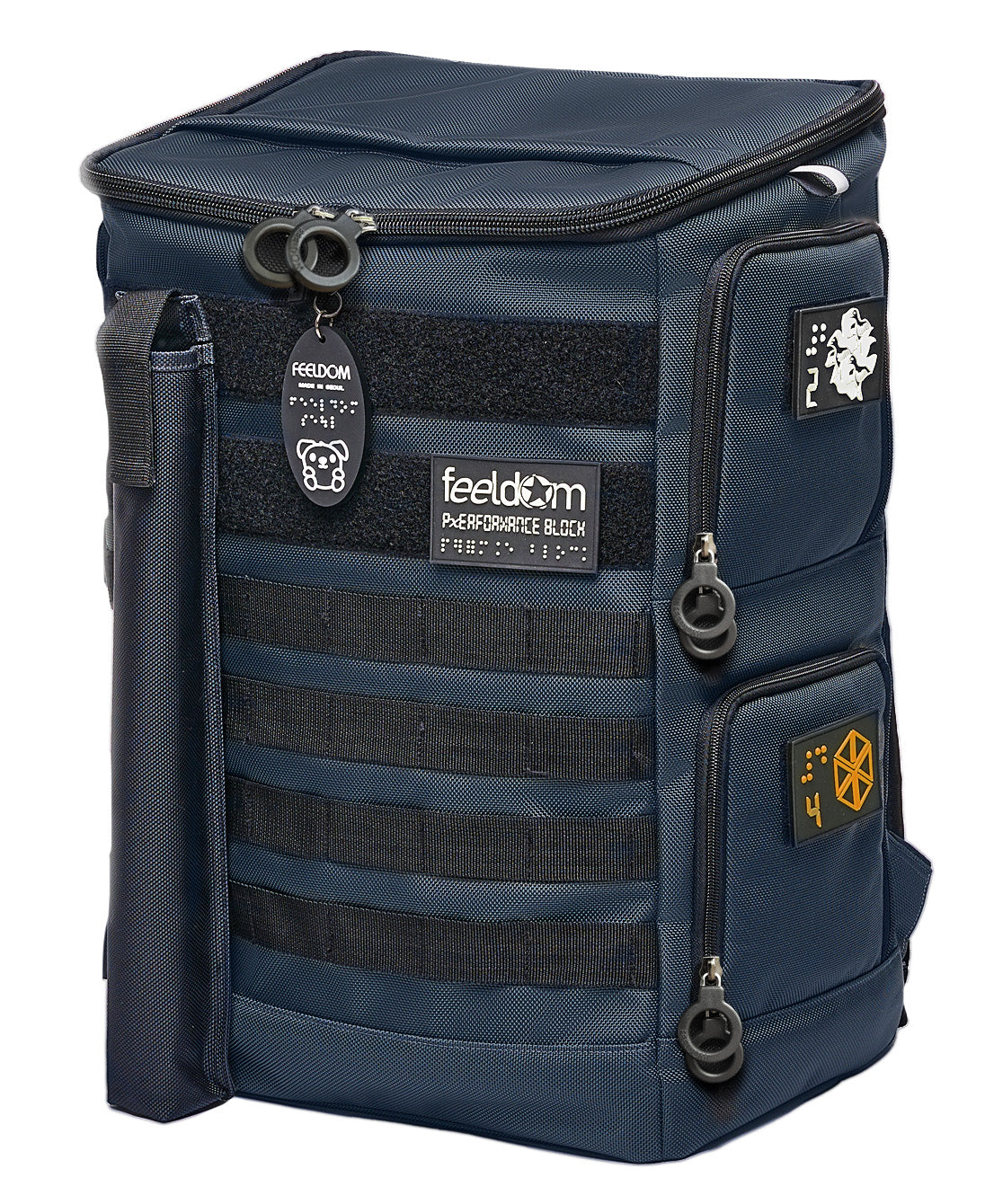 Performance Block Dark Navy ballistic nylon backpack showing the front and sides. The white and orange braille patches on the side access panels. The cane pouch is attached to the front. The Goldie keychain is attached to the front ring zippers.