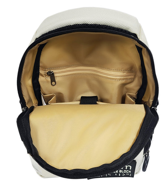 Open view of an ivory white crossbody bag with black trim and a light tan inner lining. The opeing folds down to the center of the bag allowing quick access. There is a padded divider inside as well as a smaller zipper pocket along the back wall. 