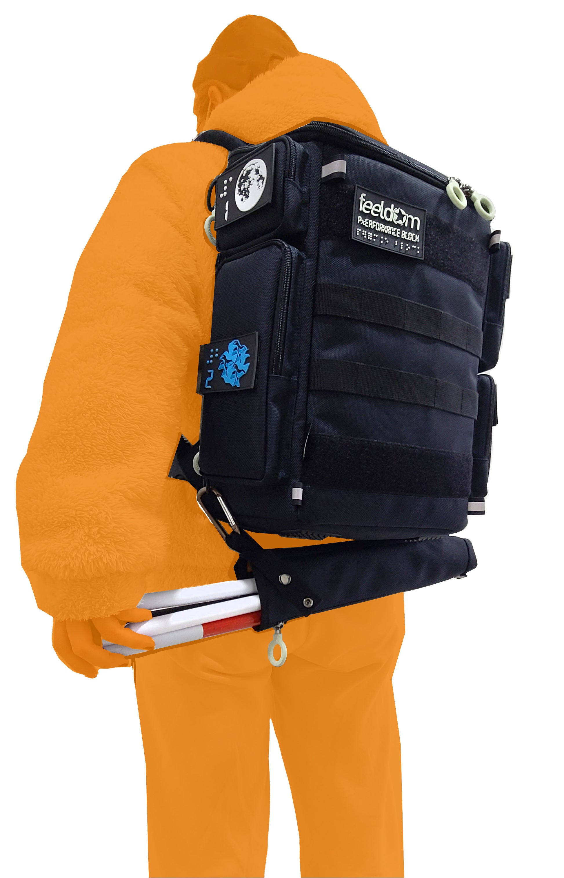 A person wearing the CITY BLOCK backpack with the cane pouch attached horizontally underneath the backpack, via carabiner and clip. The person is reaching behind to easily remove the cane from the pouch.