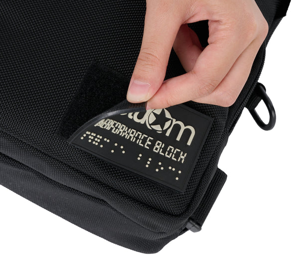 The rectangle rubber patch on the front of the bag is removable by velcro. You can even put your own patch on there!