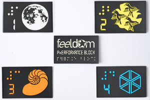5 Black rubber rectangle patches with 5 high-contrast color braille and designs with numbers 1-4. Feeldom Performance block Glow-in-the-dark Logo Patch