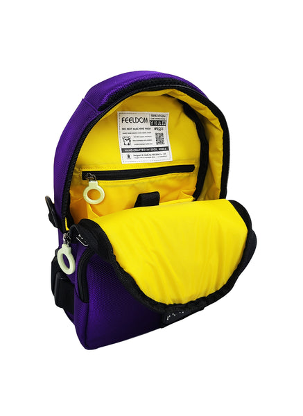 The lining of the Galaxy Purple Crossbody bag shows bright yellow inside, with a padded inner pouch and a small zipper pocket with a white ring pull. The care label is sewn inside, and it has a QR code for visually impaired persons.