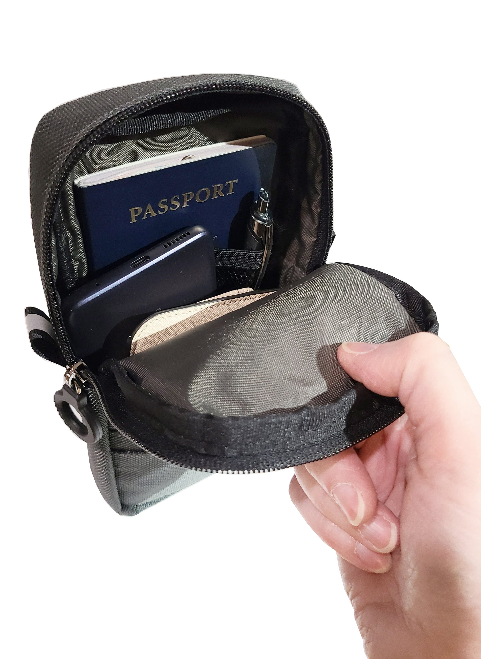 Quickie Pouch is opened up to show the main inner compartment, holding a passport, phone, pens and a wallet. Still plenty of room left over!  Padded and lined for high qualiy protection of your valuables.