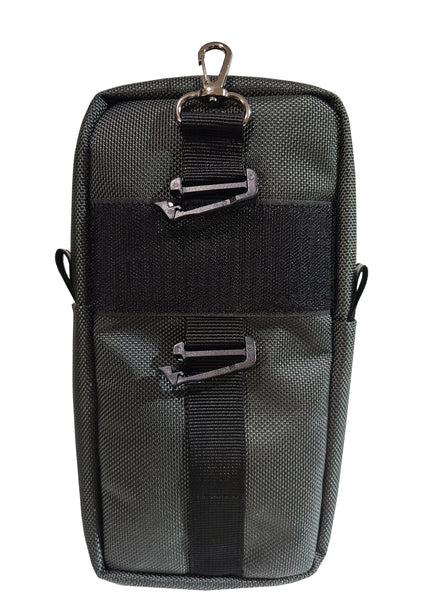 Back view of the Quikie Pouch. A black strip of velcro runs horizontally. Includes a loop for your belt carry. Black plastic webbing clips hold the pouch in place if it is attached to backpack straps. A metal clip on the top allows you to attach it to a neck strap or D-ring, etc.