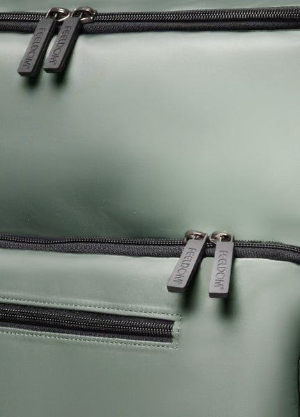 Close up detail of the luxurious finish of smooth and shiny nylon. Black smooth zippers and premium embossed black rubber zippers pulls.