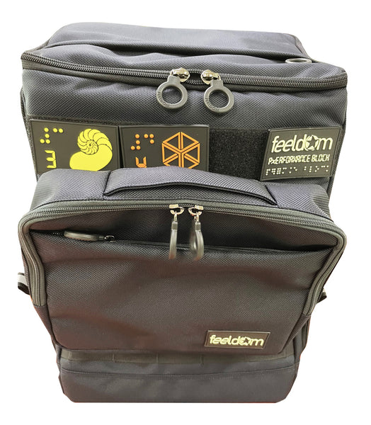 Front view of Feeldom's Performance Block Large bag with Tech Pouch attached to the front of the bag. It attaches to the webbing and is stabilized by a velcro strip along the back.