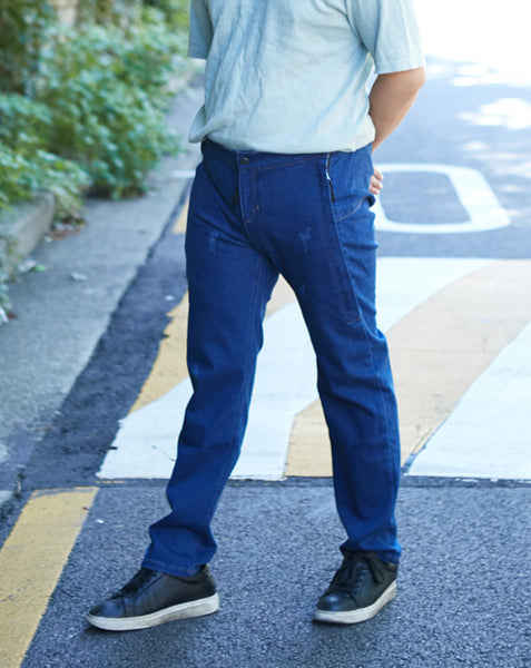 A guy is wearing the Feeldom Real Jeans Hipster model. They are relaxed fit with zipper openings on both sides of the jean from waistband to mid-thigh. Closure is hook and Loop, but with a metal snap-look on the front, and normal-looking fly area. They are flexible Spandex cotton blend.